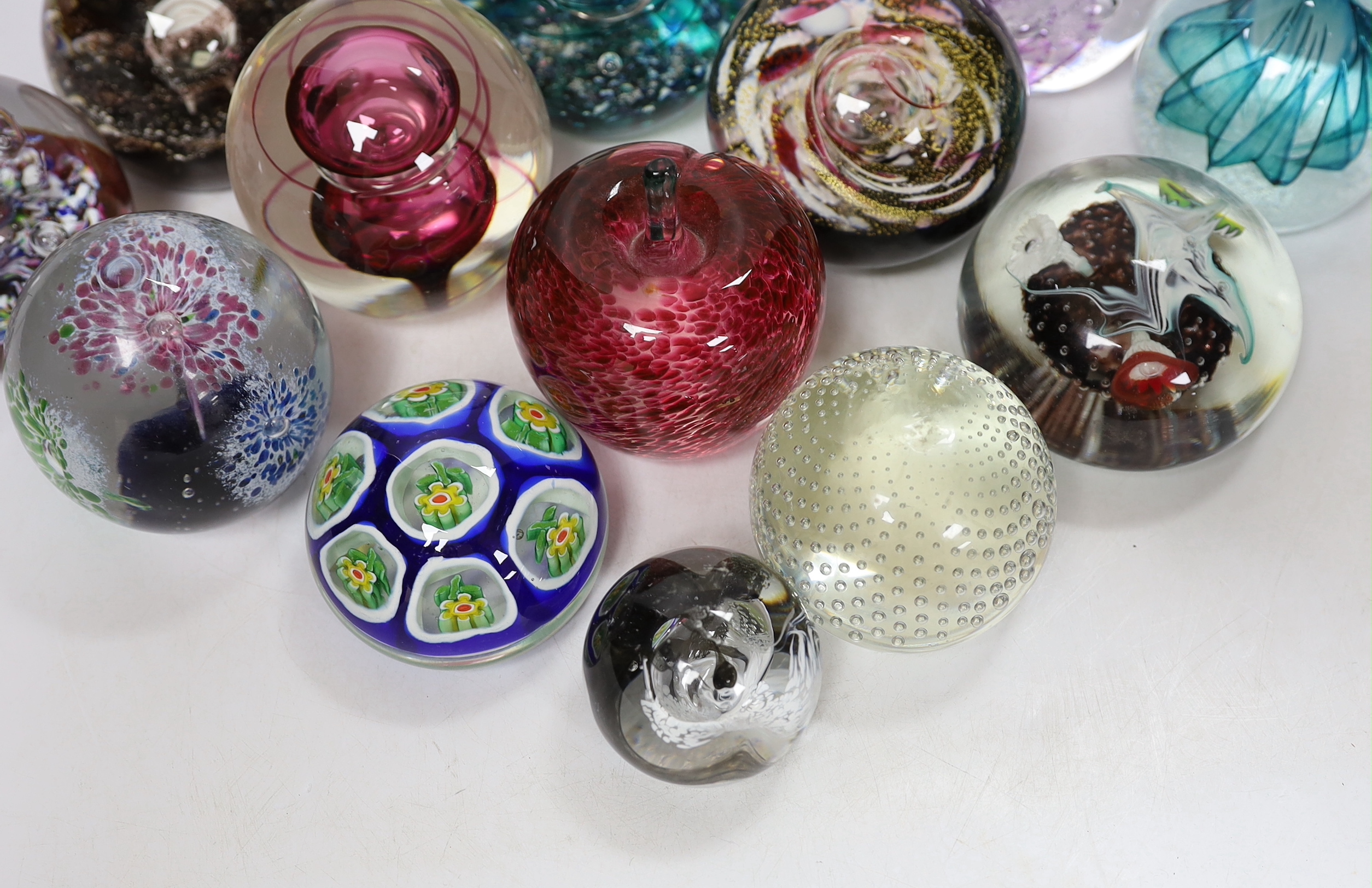 Thirteen glass paperweights including Caithness and Murano, largest 9cm in diameter